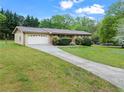 Well-maintained one-story home with a two-car garage and a long driveway extending to the house at 2310 Rubart Dr, Marietta, GA 30066
