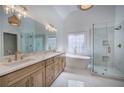 Bright bathroom featuring a soaking tub, a frameless shower, and dual sinks with stone countertops at 1043 Middlebrooke Dr, Canton, GA 30115