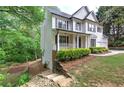 Two-story home with a covered porch and beautiful landscaping surrounding the property at 1043 Middlebrooke Dr, Canton, GA 30115