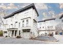 A well-maintained townhome showcasing its classic architectural style, private garages, and serene outdoor seating area at 151 Flat Shoals Ave # 13, Atlanta, GA 30316