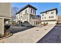 Exterior view of townhomes with private entrances, attached garages, and a neatly paved driveway at 151 Flat Shoals Ave # 13, Atlanta, GA 30316