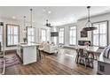 An open-concept living space featuring hardwood floors, a kitchen island, and plenty of natural light from the windows at 151 Flat Shoals Ave # 13, Atlanta, GA 30316