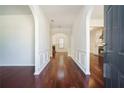 Inviting foyer with gleaming hardwood floors, arched doorways, and views of the fireplace at 1916 Oakwood Grove Dr, Snellville, GA 30078
