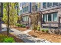 Charming townhome exteriors display brick accents, landscaped yards, and inviting walkways under a sunny sky at 383 Pratt Se Dr # 504, Atlanta, GA 30315