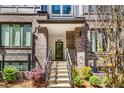 Inviting townhome entrance features steps, a covered porch, and beautifully landscaped surroundings at 383 Pratt Se Dr # 504, Atlanta, GA 30315