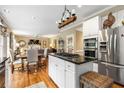 Open kitchen with a granite island, stainless steel appliances, and hardwood floors at 4223 Millside Se Walk, Smyrna, GA 30080