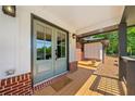 Inviting front porch with a light green double door and 