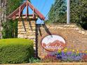 Stone community sign with colorful flowers and landscaping at the entrance of Anatole at 7154 Sw Chara Sw Ln, Atlanta, GA 30331