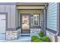 Inviting front entrance with brick accents and a glass-paneled door and a 'Welcome' sign at 7154 Sw Chara Sw Ln, Atlanta, GA 30331