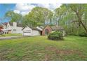 Single-story home with attached garage, brick accent window, and large front yard at 3719 Bomar Rd, Douglasville, GA 30135