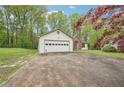 Attached two-car garage with a concrete driveway and a view of the home's front facade at 3719 Bomar Rd, Douglasville, GA 30135