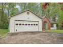 Two-car attached garage with brick accents and an arched window at 3719 Bomar Rd, Douglasville, GA 30135