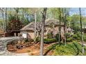 Spacious brick home with a fire pit and outdoor seating area, perfect for entertaining at 5520 Glen Errol Rd, Atlanta, GA 30327