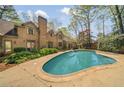 Backyard with a refreshing private pool, patio, and well-maintained landscaping at 5520 Glen Errol Rd, Atlanta, GA 30327