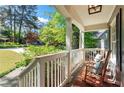 Inviting front porch with rocking chairs, white railings, and a peaceful view of the neighborhood at 2336 Armand Ne Rd, Atlanta, GA 30324