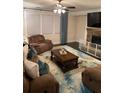 Inviting living room with a stone fireplace, plush seating, and a stylish area rug creating a cozy atmosphere at 3716 Derringer Rdg, Loganville, GA 30052