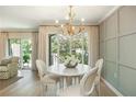 Dining room featuring decorative lighting, neutral paint, and a beautiful view of trees at 39 Ivy Gates Ne, Atlanta, GA 30342