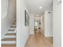 Bright hallway features hardwood floors, staircase, coat closet, and access to living areas at 39 Ivy Gates Ne, Atlanta, GA 30342