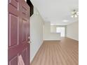 Bright living room features modern floors, fresh neutral paint and abundant natural light from the sliding doors at 7112 Brookview Way, Riverdale, GA 30274