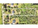 Aerial view outlining the 3.82 acre lot that the home and the shed are built on surrounded by lush trees at 719 Fairview Rd, Brooks, GA 30205
