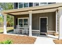 Charming front porch with rocking chairs, offering a cozy and inviting entryway to the home at 719 Fairview Rd, Brooks, GA 30205