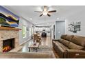 Inviting living room featuring a brick fireplace, comfortable leather sofas, and an open layout at 719 Fairview Rd, Brooks, GA 30205