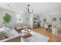 Open-concept living and dining area with hardwood floors and modern lighting at 912 Fairburn Nw Rd, Atlanta, GA 30331