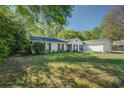 Well-maintained home featuring classic shutters and lush green lawn on a sunny day at 2340 Rolling Acres Sw Dr, Conyers, GA 30094