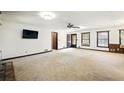 Large living room featuring neutral carpet and multiple windows at 2846 Spring Lake Dr, Buford, GA 30519