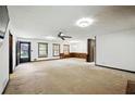 Spacious living room featuring neutral carpet, ceiling fan and multiple windows at 2846 Spring Lake Dr, Buford, GA 30519