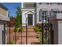 Close-up of the front entrance with a brick pathway, wrought iron gate, and meticulously maintained landscaping at 3890 The Battery, Duluth, GA 30096