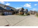 Beautiful home exterior with a large driveway, three-car garage, and attractive landscaping at 120 Chastain Nw Rd # 608, Kennesaw, GA 30144
