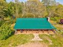 An aerial shot of a home featuring a large green roof and wrap around porch at 1288 Reavesville Rd, Bowdon, GA 30108