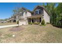 Charming two-story home with stone and siding exterior with a covered porch and a two car garage at 1815 Wellston Dr, Lawrenceville, GA 30043