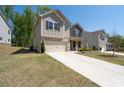Inviting two-story home with stone accents, a well-manicured lawn, and a two-car garage at 1815 Wellston Dr, Lawrenceville, GA 30043
