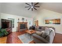 Inviting living room with a stone fireplace, vaulted ceiling, and hardwood floors at 209 Red Fern Ct, Canton, GA 30114