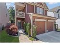 Inviting exterior with a two-car garage, balcony, and beautiful landscaping at 261 Highland Village Ln, Woodstock, GA 30188