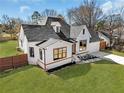Aerial view of a lovely white brick home with a manicured lawn and mature trees at 1774 Vesta Ave, Atlanta, GA 30337