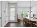Bright dining room with modern light fixture, wood floors, and natural light at 2614 Talley St, Decatur, GA 30030