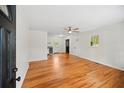 Bright living room featuring hardwood floors, a ceiling fan, and neutral paint at 262 E Main St, Rutledge, GA 30663