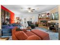 Cozy living room with a stone fireplace, plush seating, and a ceiling fan at 4941 N Helton Rd, Winston, GA 30187