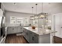 Open kitchen featuring granite counters, pendant lighting, modern appliances and hardwood floors at 1008 Knoxboro Ln, Woodstock, GA 30188