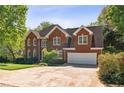 Spacious two-story red brick home with a two-car garage and a large driveway at 1755 Pinetree Pass Sw Ln, Lilburn, GA 30047