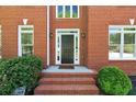 Close-up of the classic front door with brick steps, framed by sidelights and lush landscaping at 1755 Pinetree Pass Sw Ln, Lilburn, GA 30047