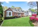Beautiful home showcasing lush landscaping, a brick facade, and well-maintained lawn, enhancing its curb appeal at 4086 Norton Se Pl, Smyrna, GA 30082