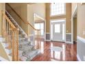 Foyer with hardwood floors, staircase, and natural light coming through the front door at 4095 Boles Creek Dr, Duluth, GA 30096