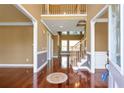 Inviting foyer with hardwood floors, staircase, and entry to other rooms of the home at 4095 Boles Creek Dr, Duluth, GA 30096