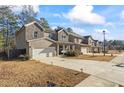 View of new two-story homes in a suburban neighborhood, showcasing front lawns and attached garages at 75 Glen Abbey Cir, Fairburn, GA 30213