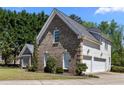 Brick home with a two car garage, manicured lawn, and tidy landscaping at 774 Mary Ann Ne Dr, Marietta, GA 30068