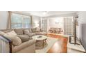 Bright living room featuring hardwood floors, a sectional sofa, and French doors to dining room at 133 Cross Gate Dr, Marietta, GA 30068